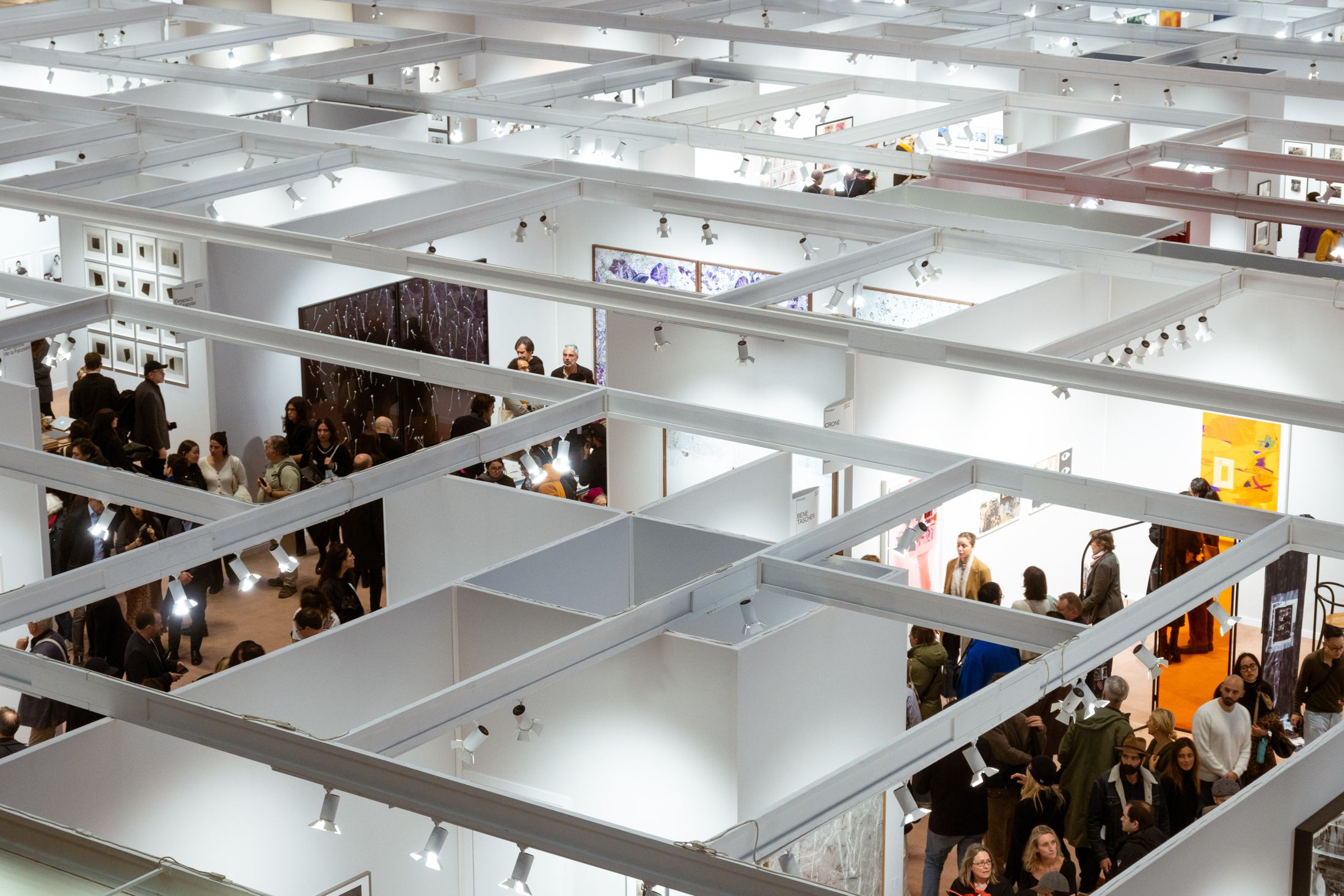 Busy indoor expo hall filled with exhibition booths and visitors