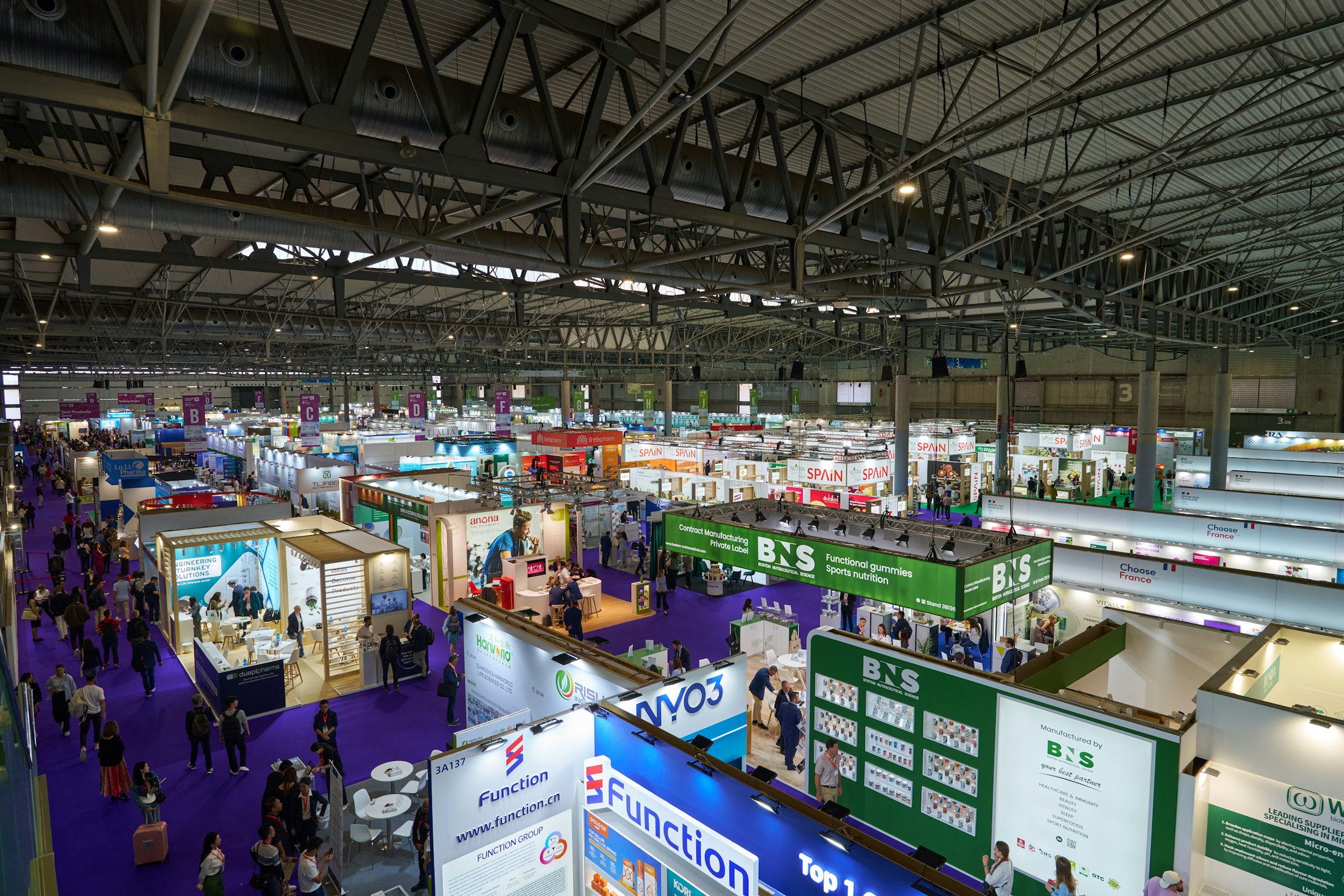 Visitors exploring wellness pavilions at the M-Health 26 health and wellbeing expo